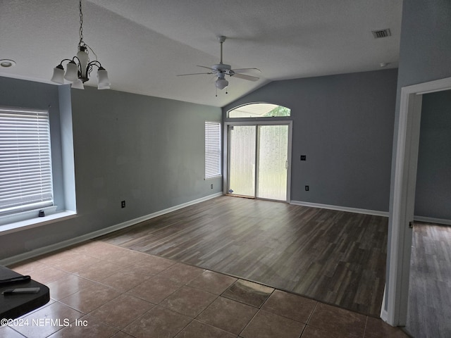 unfurnished room with ceiling fan with notable chandelier, wood-type flooring, vaulted ceiling, and a textured ceiling