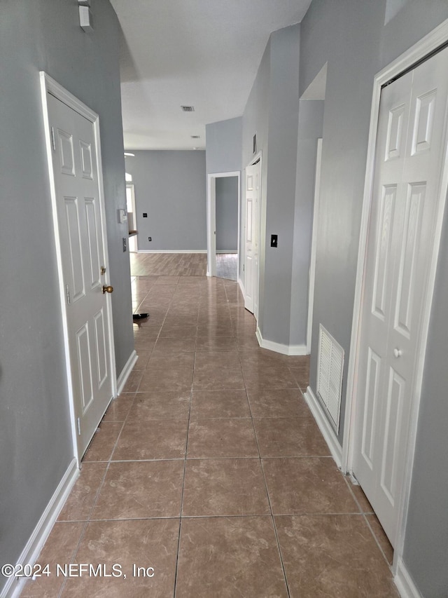 hall with tile patterned flooring