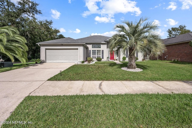 view of front of property with a front yard and a garage