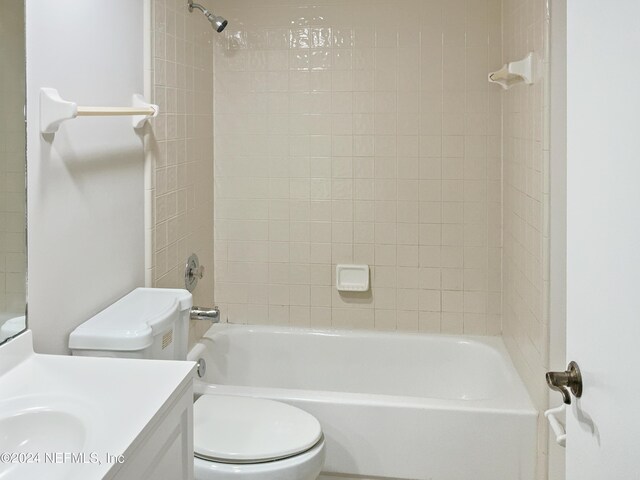 full bathroom featuring vanity, toilet, and tiled shower / bath