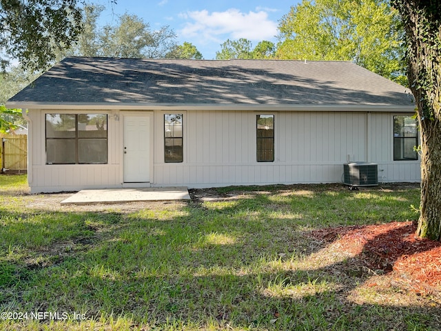 exterior space featuring cooling unit and a yard