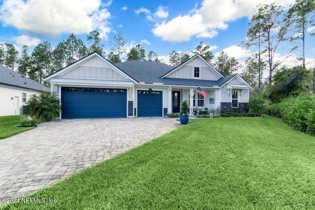 view of front of property with a garage and a front lawn