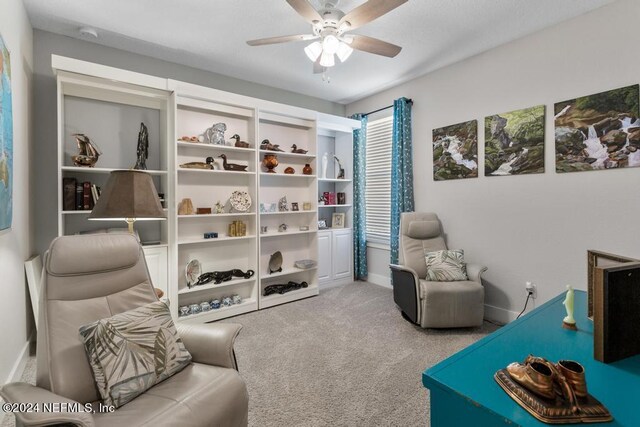 sitting room with ceiling fan and carpet floors