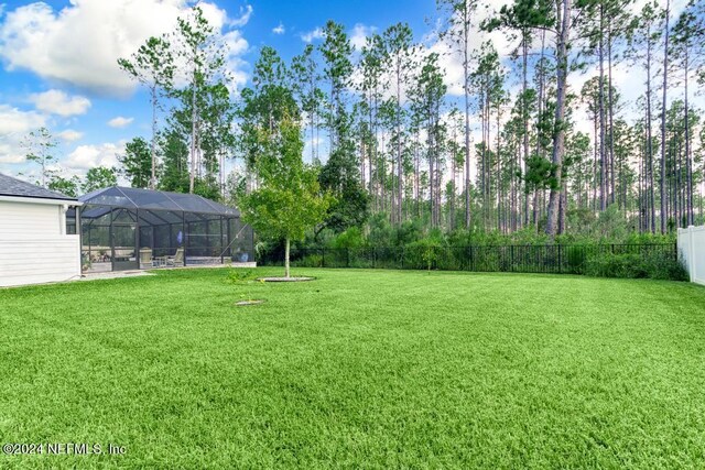 view of yard with a lanai