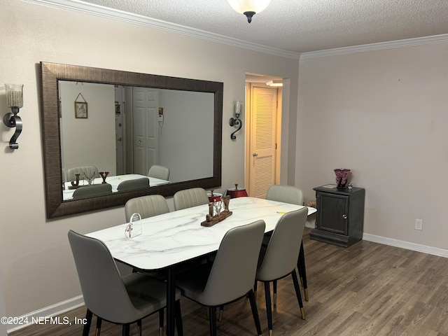 dining space featuring a textured ceiling, wood-type flooring, and ornamental molding