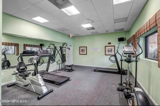 gym featuring a paneled ceiling and carpet flooring