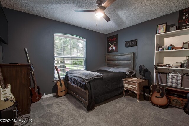 carpeted bedroom with a textured ceiling and ceiling fan