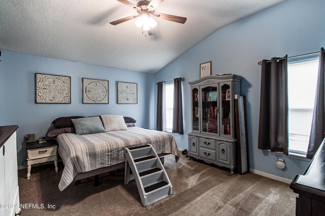 bedroom featuring carpet floors, a textured ceiling, lofted ceiling, and ceiling fan