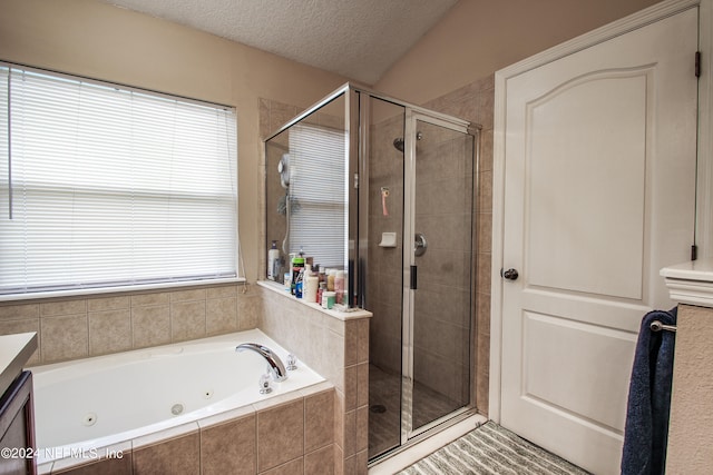 bathroom featuring a wealth of natural light, a textured ceiling, and shower with separate bathtub