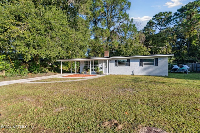 view of front of house featuring a front yard and a patio