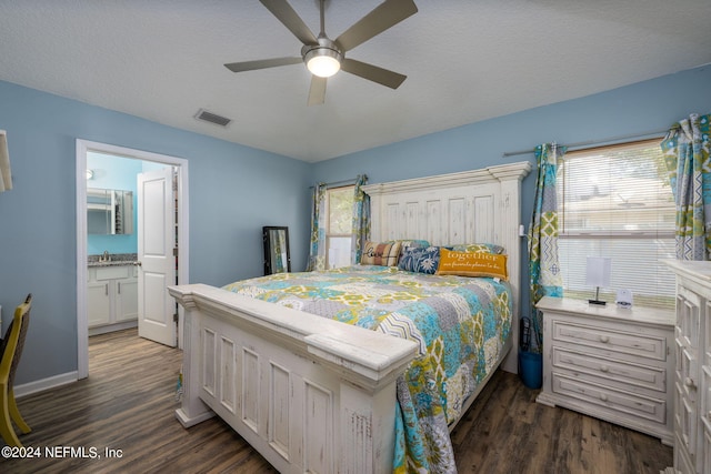 bedroom featuring ceiling fan, a textured ceiling, ensuite bath, and dark hardwood / wood-style floors