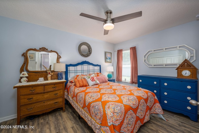 bedroom with a textured ceiling, dark hardwood / wood-style floors, and ceiling fan