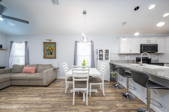 interior space with ceiling fan and hardwood / wood-style flooring