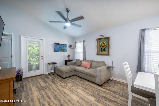 living room with ceiling fan, lofted ceiling, and dark wood-type flooring