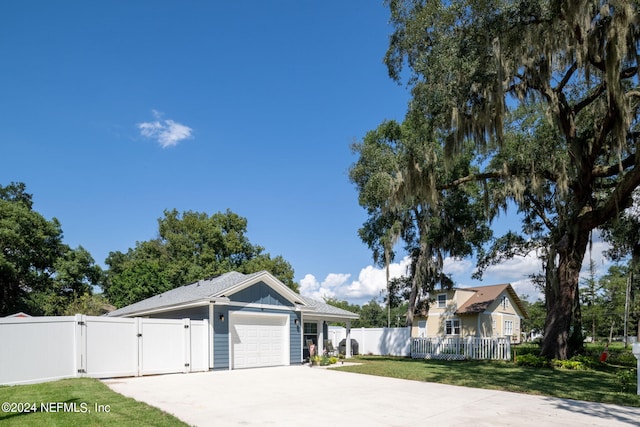 view of front of property with a garage and a front yard