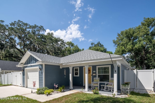 ranch-style house with a porch and a garage