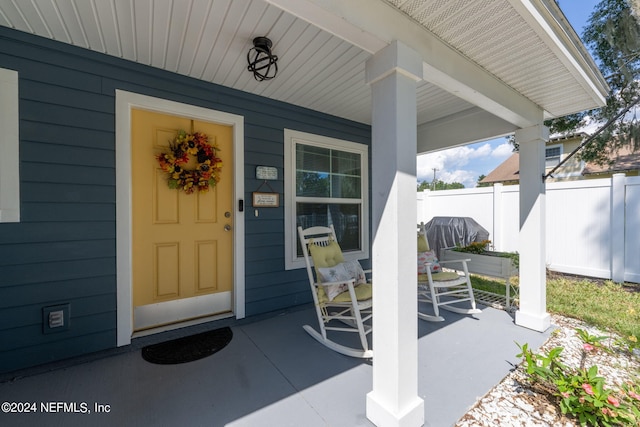 view of exterior entry with covered porch