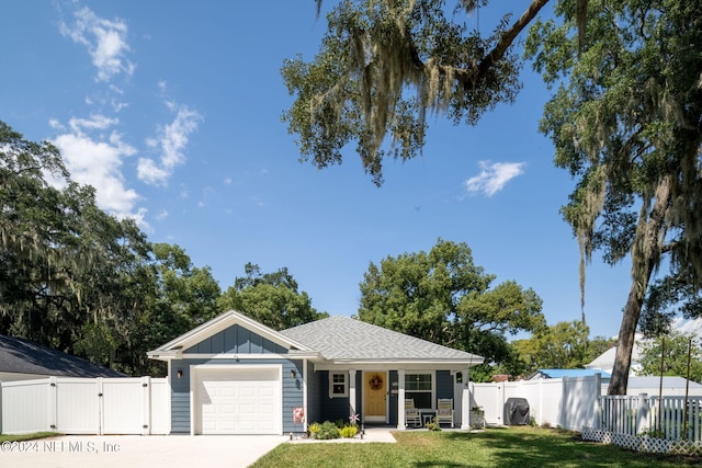 view of front of property with a garage and a front lawn