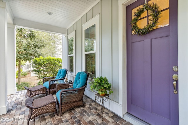 view of exterior entry featuring a porch