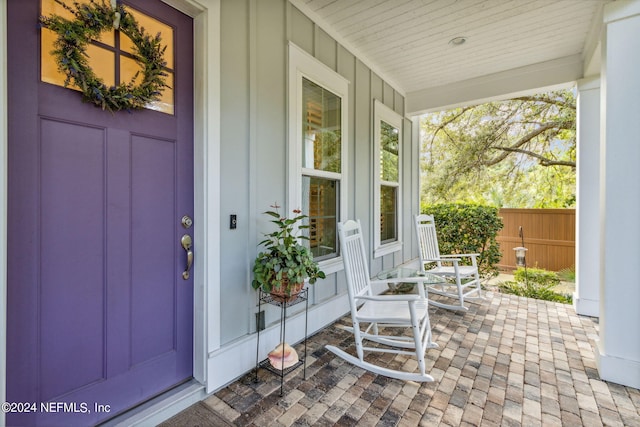 view of exterior entry with a porch