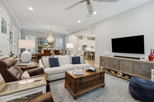 living room featuring ceiling fan and ornamental molding