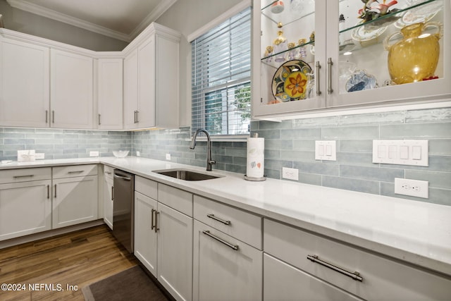 kitchen featuring dishwasher, dark wood-type flooring, sink, white cabinetry, and crown molding