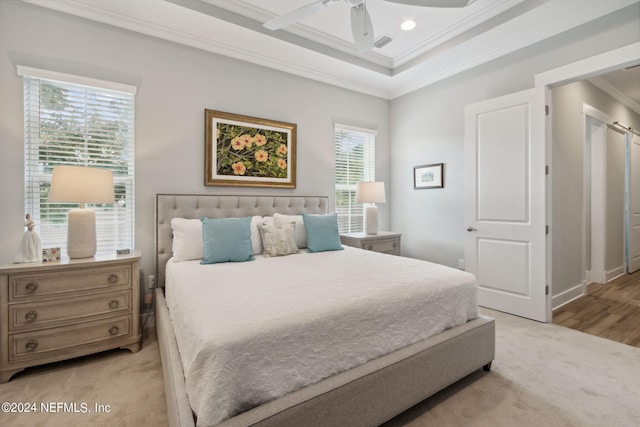 bedroom featuring multiple windows, ornamental molding, ceiling fan, and light hardwood / wood-style flooring