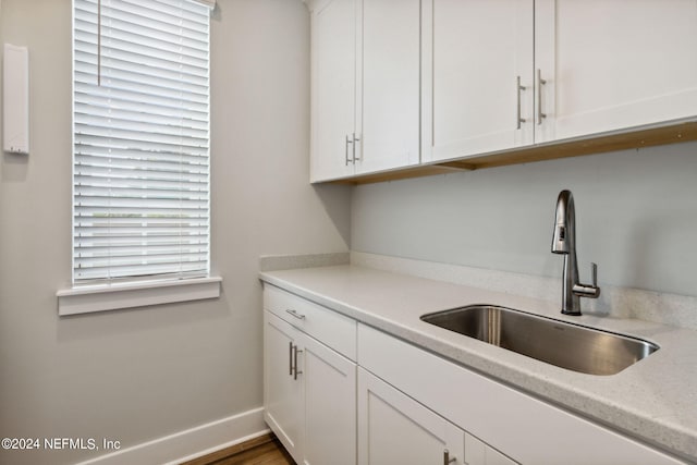 kitchen with white cabinets, dark hardwood / wood-style floors, and sink