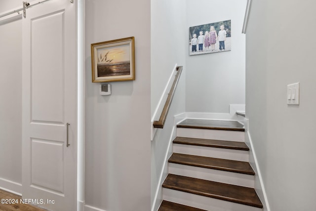 stairs featuring hardwood / wood-style flooring