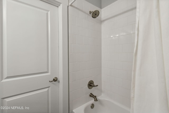 bathroom with shower / bath combination with curtain