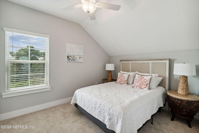 bedroom featuring ceiling fan, lofted ceiling, light carpet, and multiple windows