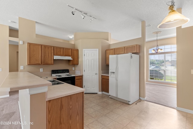 kitchen featuring kitchen peninsula, white appliances, a textured ceiling, decorative light fixtures, and a notable chandelier