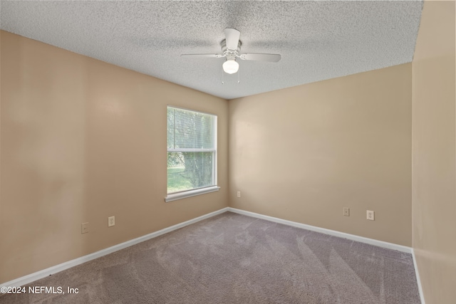 spare room with ceiling fan, carpet floors, and a textured ceiling