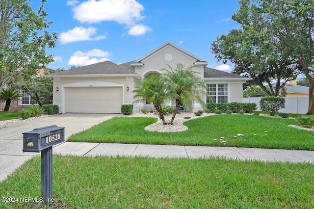 view of front of house with a front lawn and a garage