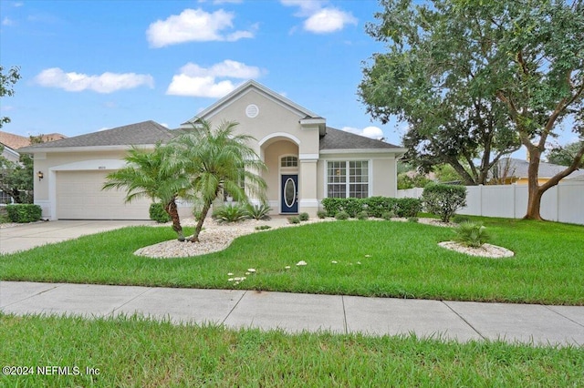 view of front of house with a front lawn and a garage