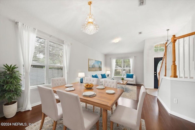 dining space featuring an inviting chandelier and dark wood-type flooring