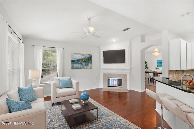 living room with wood-type flooring and ceiling fan