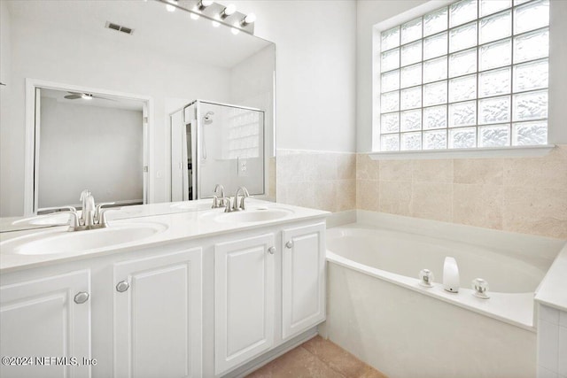 bathroom featuring vanity, plus walk in shower, and tile patterned floors