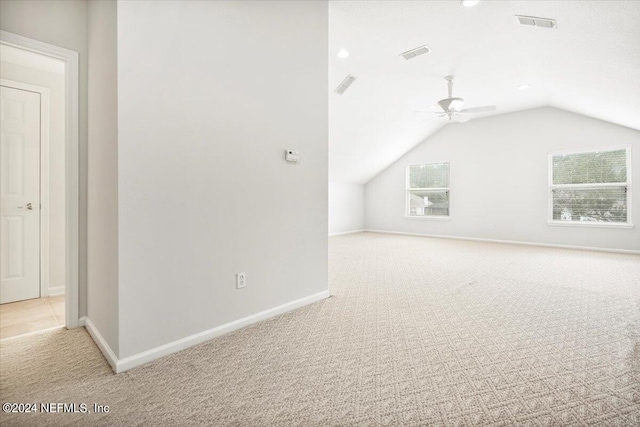 bonus room with vaulted ceiling, ceiling fan, and light colored carpet