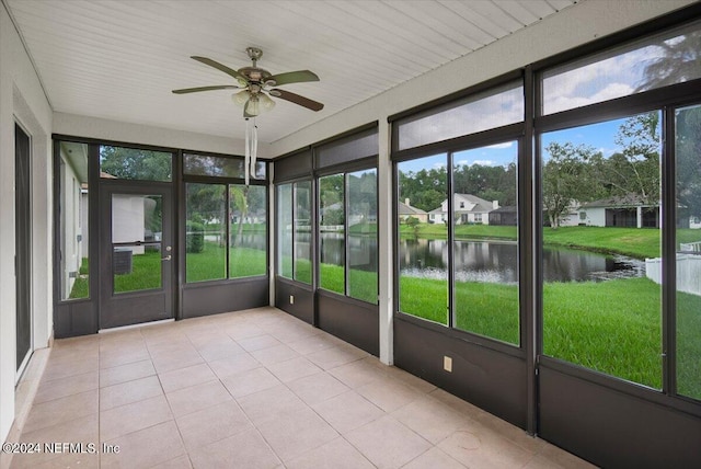 unfurnished sunroom with a water view, ceiling fan, and plenty of natural light