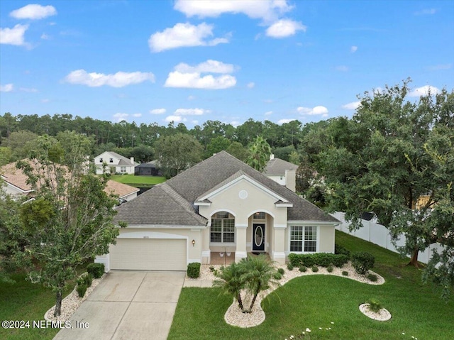 view of front of house with a garage and a front lawn