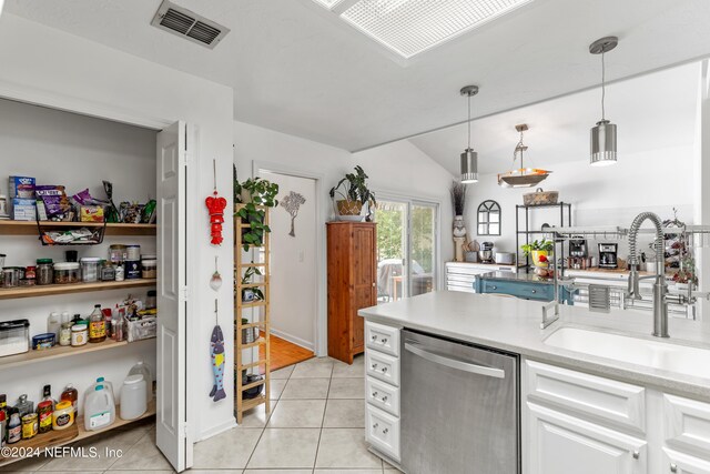 kitchen featuring white cabinets, dishwasher, hanging light fixtures, and sink