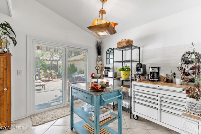 kitchen with lofted ceiling and light tile patterned flooring