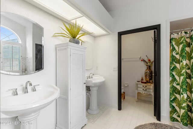 bathroom featuring sink, tile patterned floors, and toilet