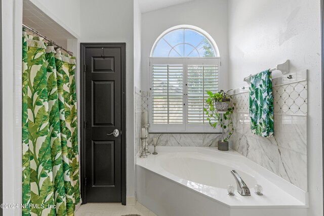 bathroom featuring plus walk in shower, lofted ceiling, and tile patterned floors