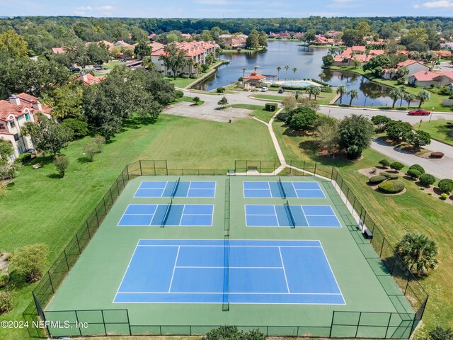 view of tennis court featuring a water view