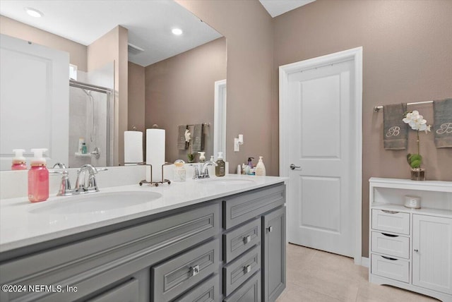 bathroom featuring vanity, tile patterned floors, and a shower with door