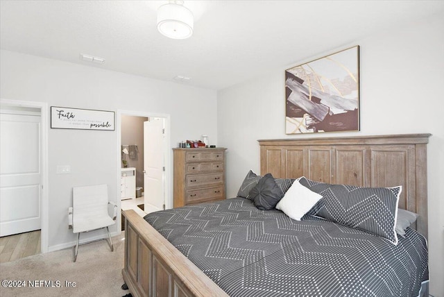 carpeted bedroom featuring connected bathroom