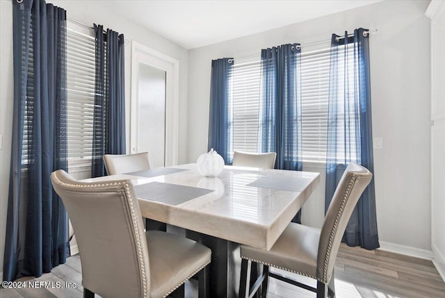 dining space with light hardwood / wood-style flooring