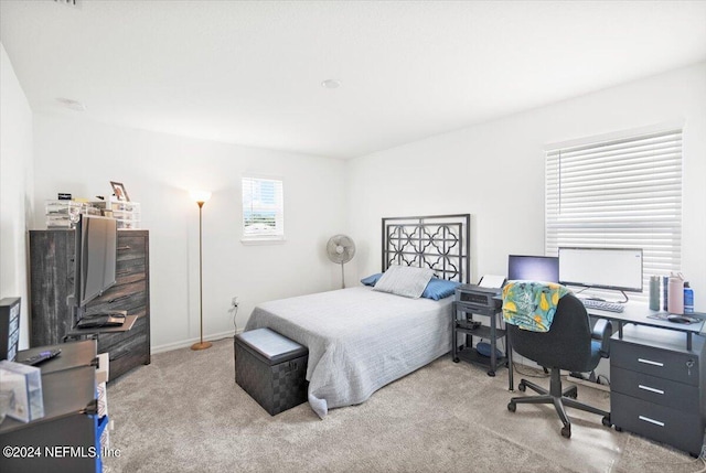 bedroom featuring light colored carpet